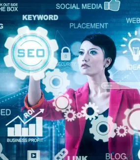 A woman in a red blazer interacts with digital marketing symbols, including SEO, keywords, and social media icons on a futuristic screen.